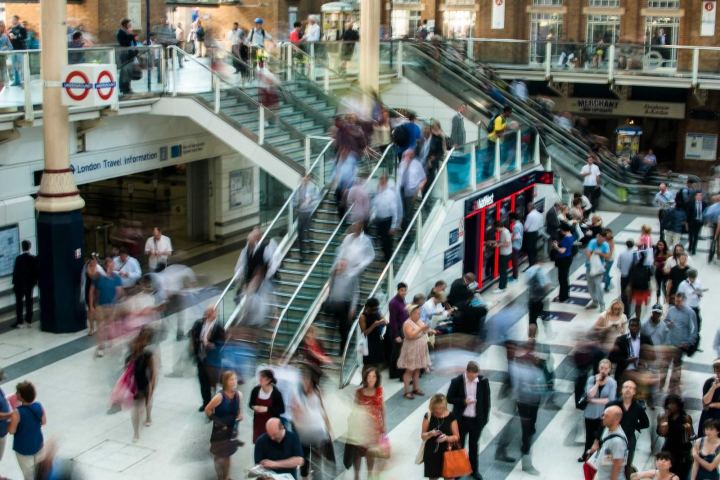 Crowds on the escalators of a busy station concourse